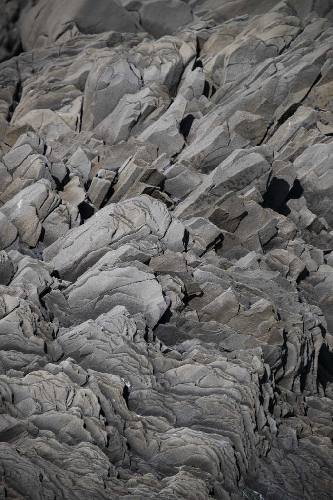 Angular, layered rock formations seen in close detail.