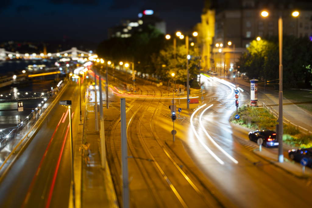 Nighttime traffic junction with sweeping light trails.