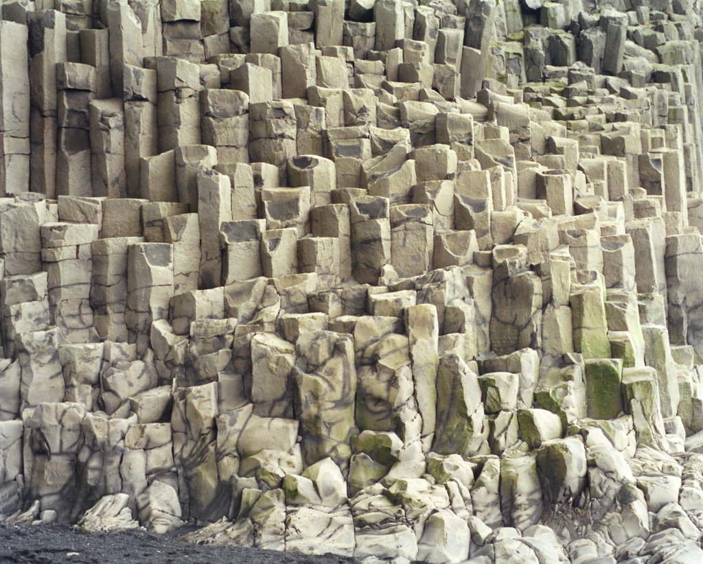 Geometric basalt columns forming a dramatic rock wall.